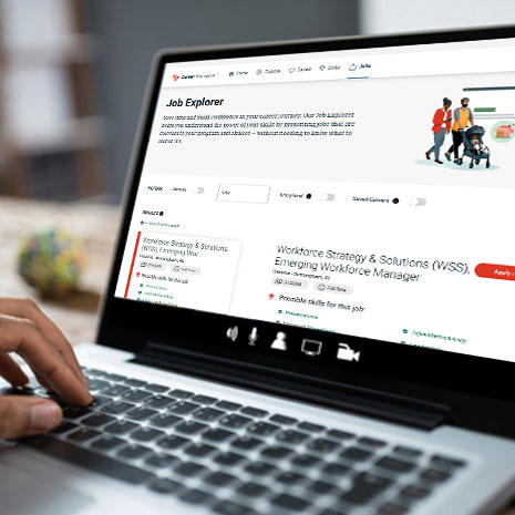 laptop open with a person using the University of Phoenix job explorer
