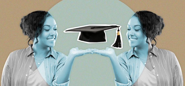 A smiling associate degree graduate holds a graduation cap