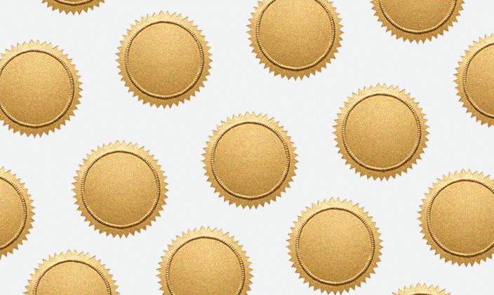 Frame is filled with gold medals on a beige background.