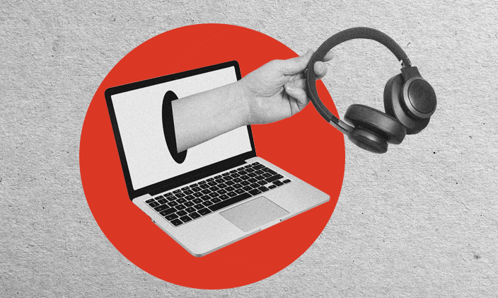 Open laptop with a hand extending from screen and holding a pair of headphones.