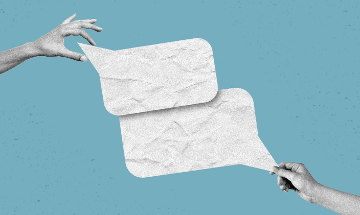 Two hands outstretched each holding a white paper text bubble representing announcement of UOPX embedding AI skills across online degree programs.
