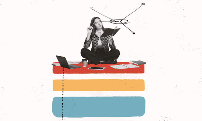 A woman sitting cross-legged next to an open laptop and looking upwards.