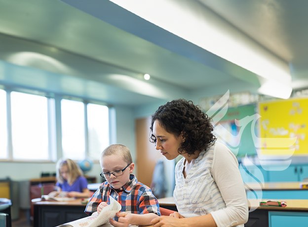 Educator helping child in classroom