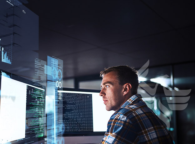 IT worker reviewing information on a computer screen